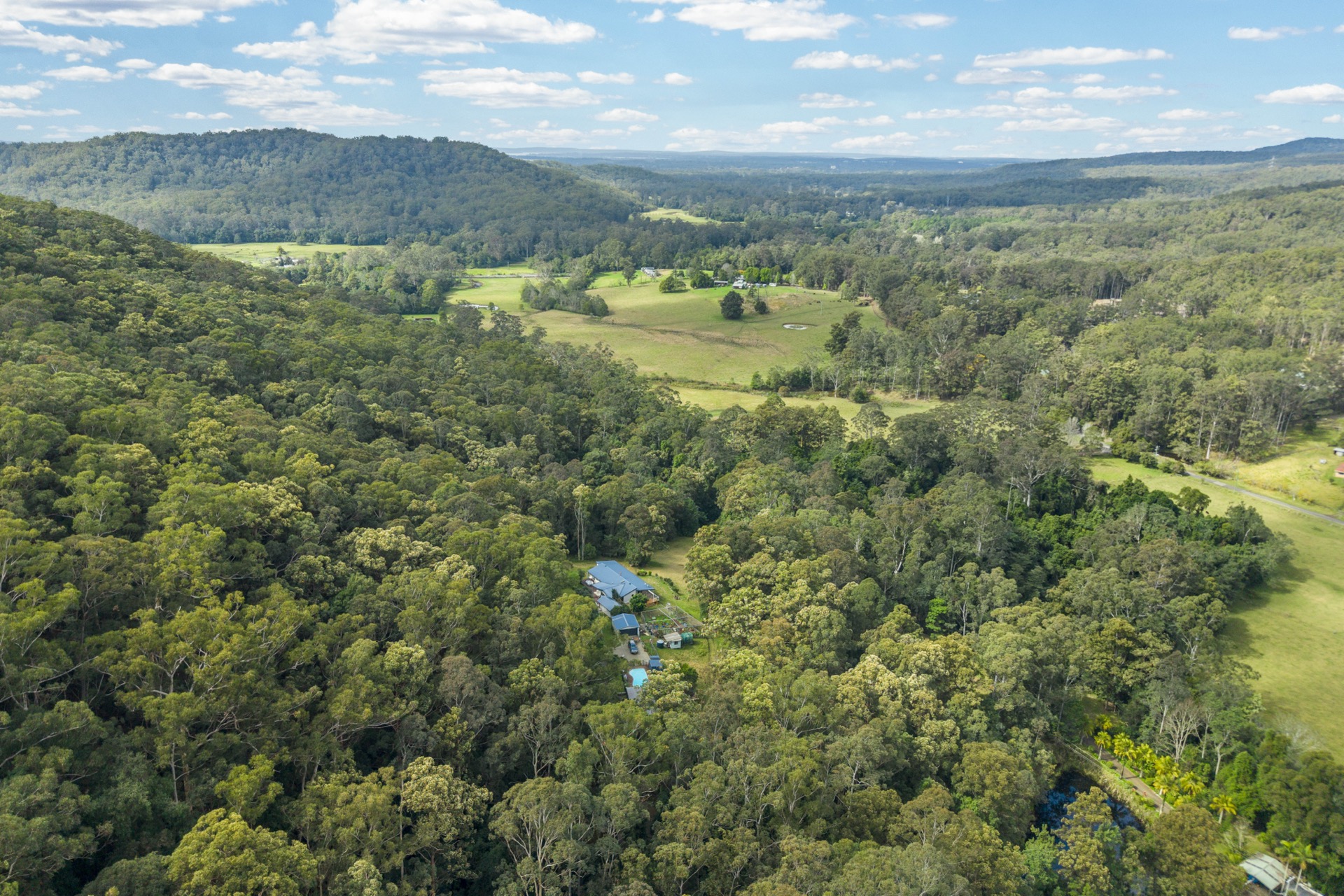 Aerial view of 32 Geerings Road Martinsville, home nestled among established forest with pool and shed