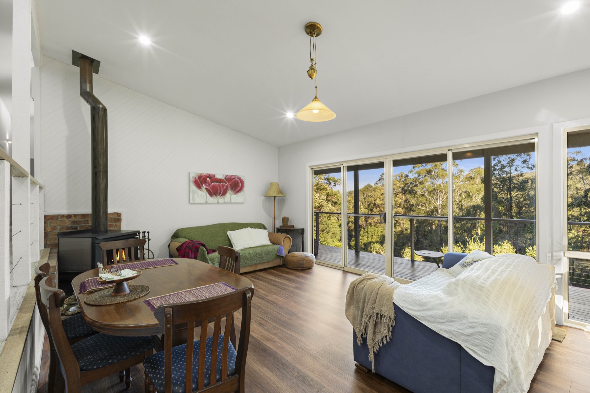 Vaulted open-plan living area with slow combustion fireplace and glass doors to the deck, 32 Geerings Road Martinsville